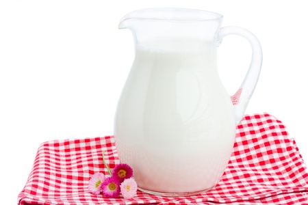 glass pitcher full of milk   isolated on white backgroundの写真素材