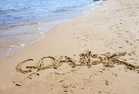 Gdansk sign on the beach of Baltic Sea の写真素材