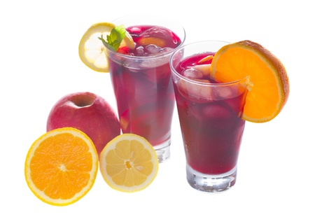cold sangria in tall glasses with fruits isolated on white backgroundの写真素材