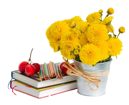 Books and yellow mums flowers on white back to school conceptの写真素材