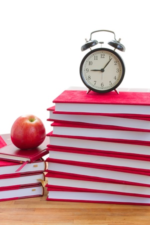 alarm clock and books on a table isolated on white backgroundの写真素材