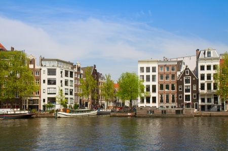 Old houses of  Amsterdam on Amstel river, Netherlandsの写真素材