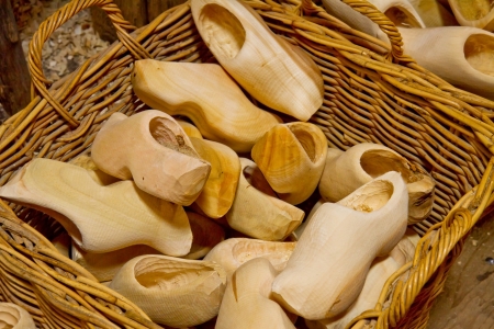 traditional dutch wooden shoes clogs in basketの写真素材
