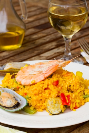 Dining  -  plate with paella and glass of wineの写真素材