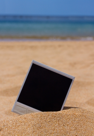instant photo in sand on sea shoreの写真素材