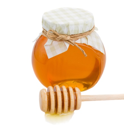 glass honey pot   and stick isolated on white backgroundの写真素材