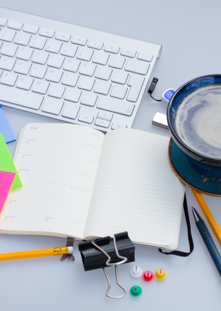 open blank note book with stationery and keyboard  on working tableの写真素材