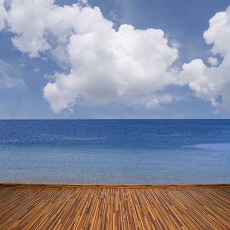 seascape with calm water, clouds and wooden planksの写真素材
