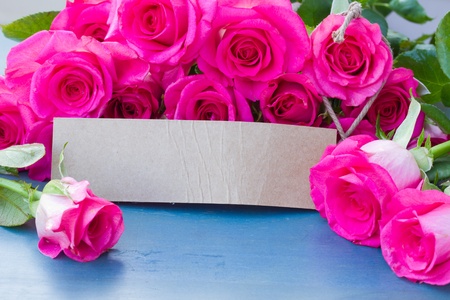 fresh pink roses on wooden table with paper tagの写真素材