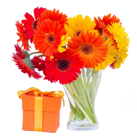 gerbera flowers in glass vase with gift box  isolated on white backgroundの写真素材
