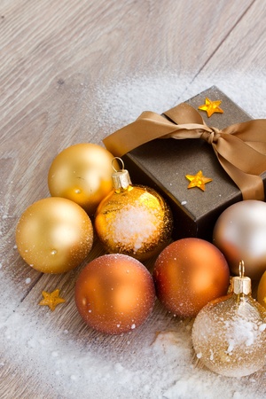 golden x-mas  decorations and gift box close up  on wooden backgroundの写真素材
