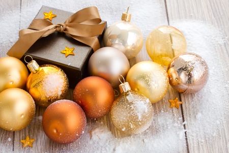 golden x-mas  balls and gift box on wooden backgroundの写真素材