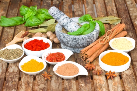 colorful mix of plates spices and mortar on wooden tableの写真素材