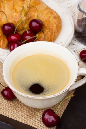 breakfast with  black coffee,  croissants and  cherryの写真素材