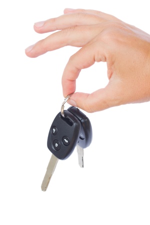 hand holding a car keys isolated on white backgroundの写真素材