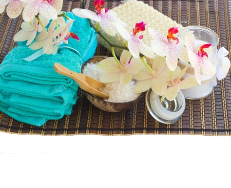 blue towels, sea salt and orchid flowers with  aroma candle isolated on white backgroundの写真素材