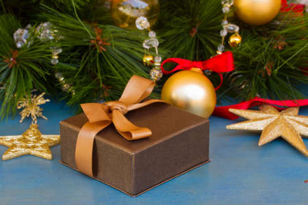 x-mas  gift box laying under fir treeの写真素材