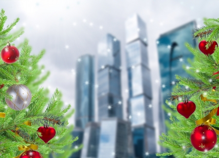 christmas decorated trees on big city backgroundの写真素材