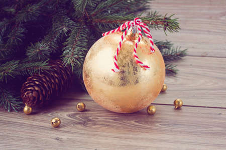 golden  christmas ball  decoration with fir tree, retro tonedの写真素材