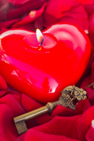 Key with the candle  heart as a symbol of loveの写真素材