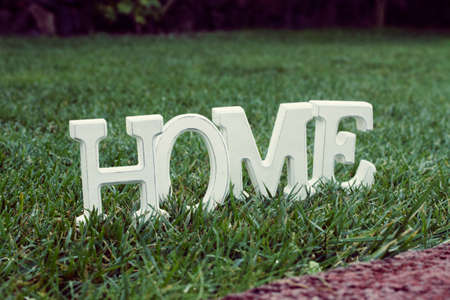 White letters Home in backyard green grass lawnの写真素材