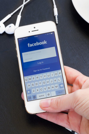 WARSZAWA, POLAND - APRIL 01, 2014: Loging in Facebook app on Iphone5s with help of finger print....