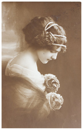 POLAND, WARSAW - CIRCA 1913: old photo portrait of young woman with flowers. Illustrative Image, subject of human interestのeditorial素材