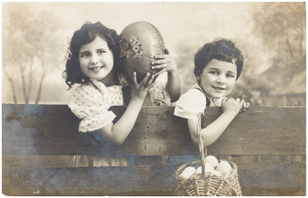 POLAND, WARSAW - CIRCA 1916 : old photo  of happy young boy and girls with easter eggs. Illustrative...