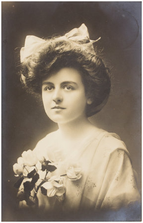 POLAND, WARSAW - CIRCA 1913: old photo portrait of young woman with flowers. Illustrative Image, subject of human interestのeditorial素材