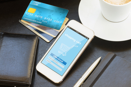 mobile shopping concept  -  virtual shop on phone screen with credit cards and walletの写真素材