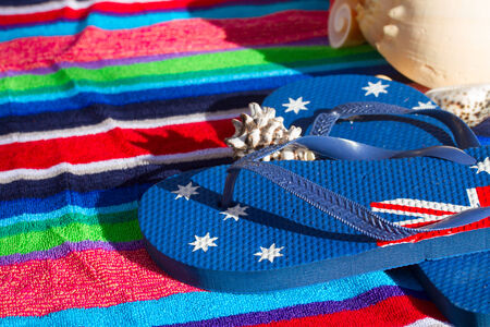blue flip flops on beach towel close upの写真素材