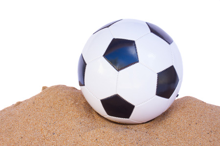 football ball in sand isolated on white background borderの写真素材