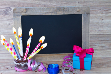 empty black chalk board with birthday  cupcake and gift boxの写真素材