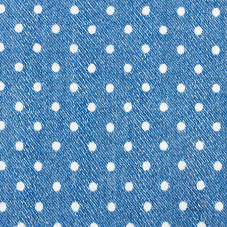 background of blue jeans with white polka dot patternの写真素材