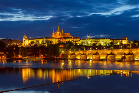 skyline of Prague with Vitus cathedral and Charles bridge at night, Czech Republicの写真素材
