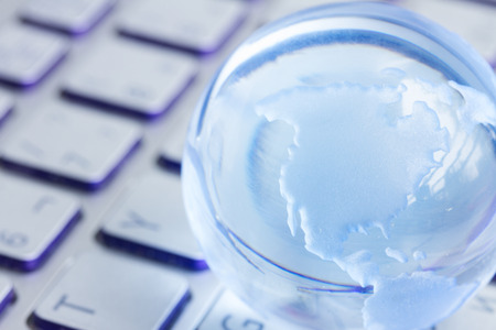 business concept with  globe on laptop keyboardの写真素材