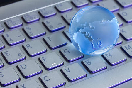 business concept with  globe on laptop keyboardの写真素材