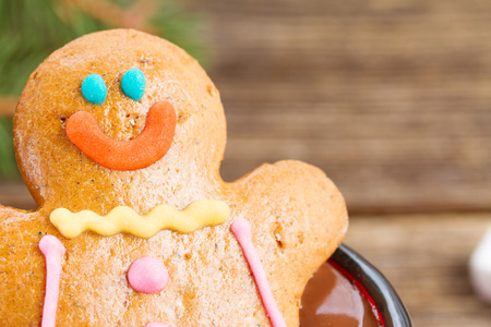 one Gingerbread man close up on wooden background