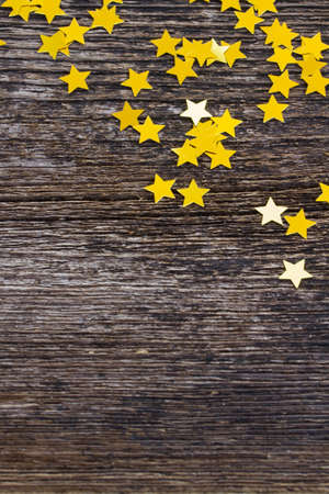 christmas shiny golden stars decorations on wood with copy spaceの写真素材