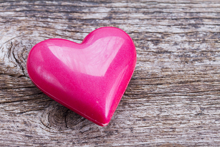 one pink heart laying on  wooden backgroundの写真素材