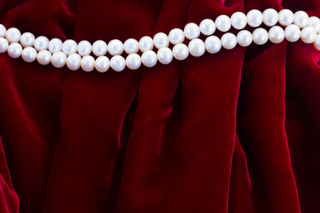 abstract texture of  soft dark red velvet background with pearl jeweleryの写真素材