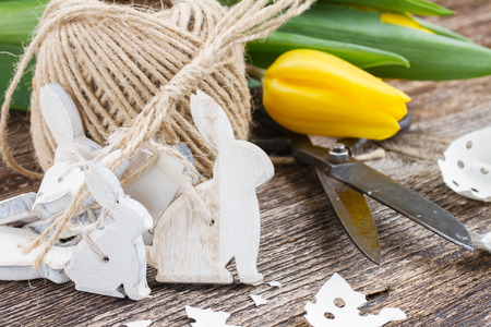 white easter rabbits and fresh yellow tulip