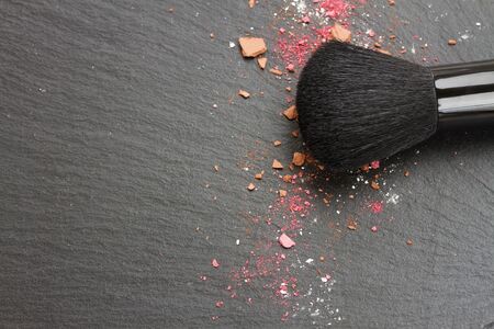 brushe and crushed  eye  shadows with copy space on black tableの写真素材