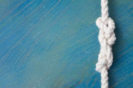 marine knot on blue wood  with copy spaceの写真素材