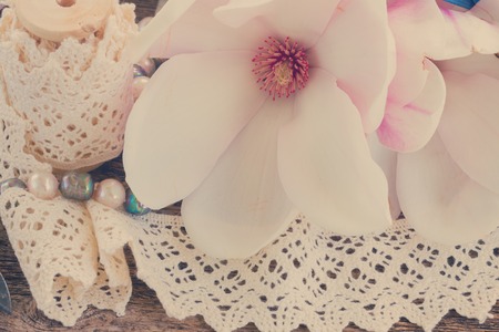 magnolia fpink resh flowers with pearls and vintage lace, retro tonedの写真素材