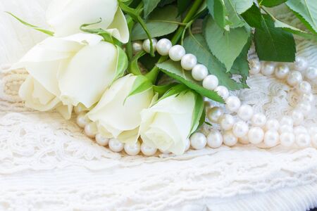 white fresh  roses buds with lace and pearls jeweleryの写真素材