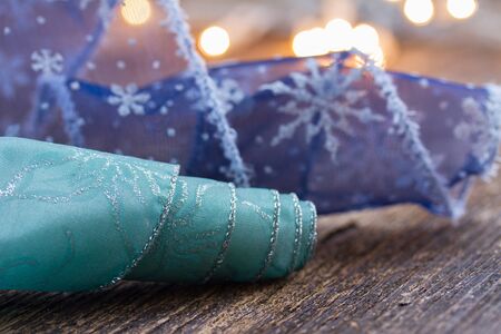 blue ribbons with  christmas defocused lights in backgroundの写真素材