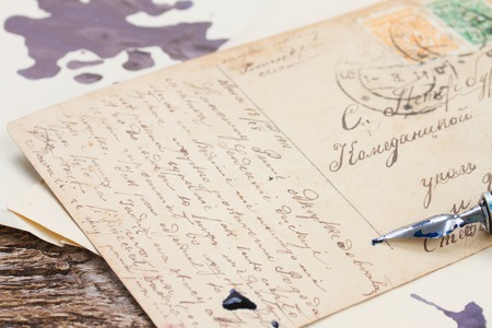 old  feather pen on  handwritten letter backgroundの写真素材