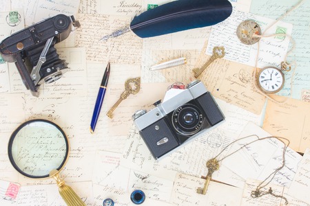 old mails background with vintage watch, feather pen, camera and keyの写真素材