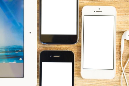 Phones   with blanc screen on wooden table
